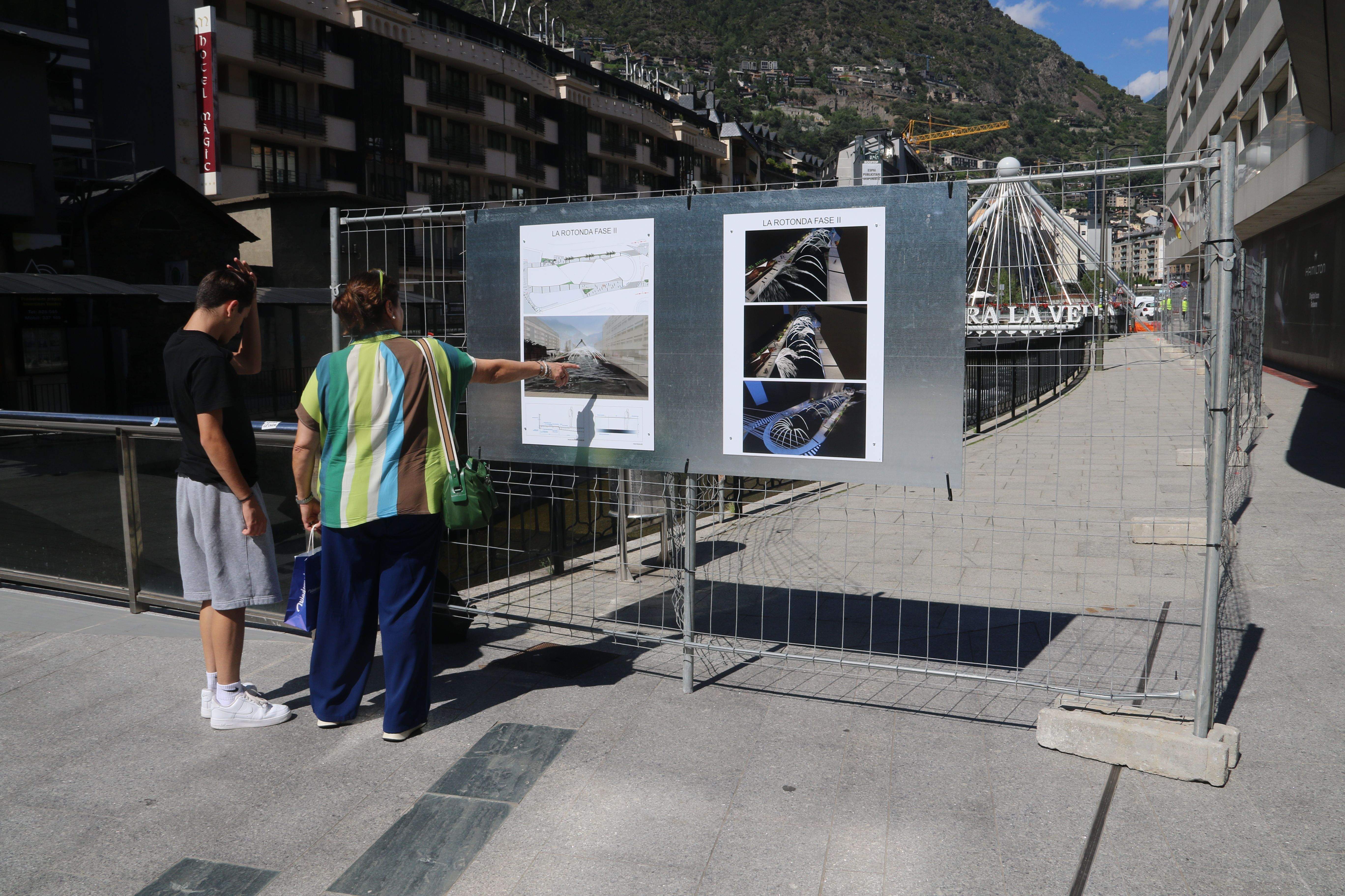 Una dona comentant el projecte amb un fill seu, aquesta tarda.