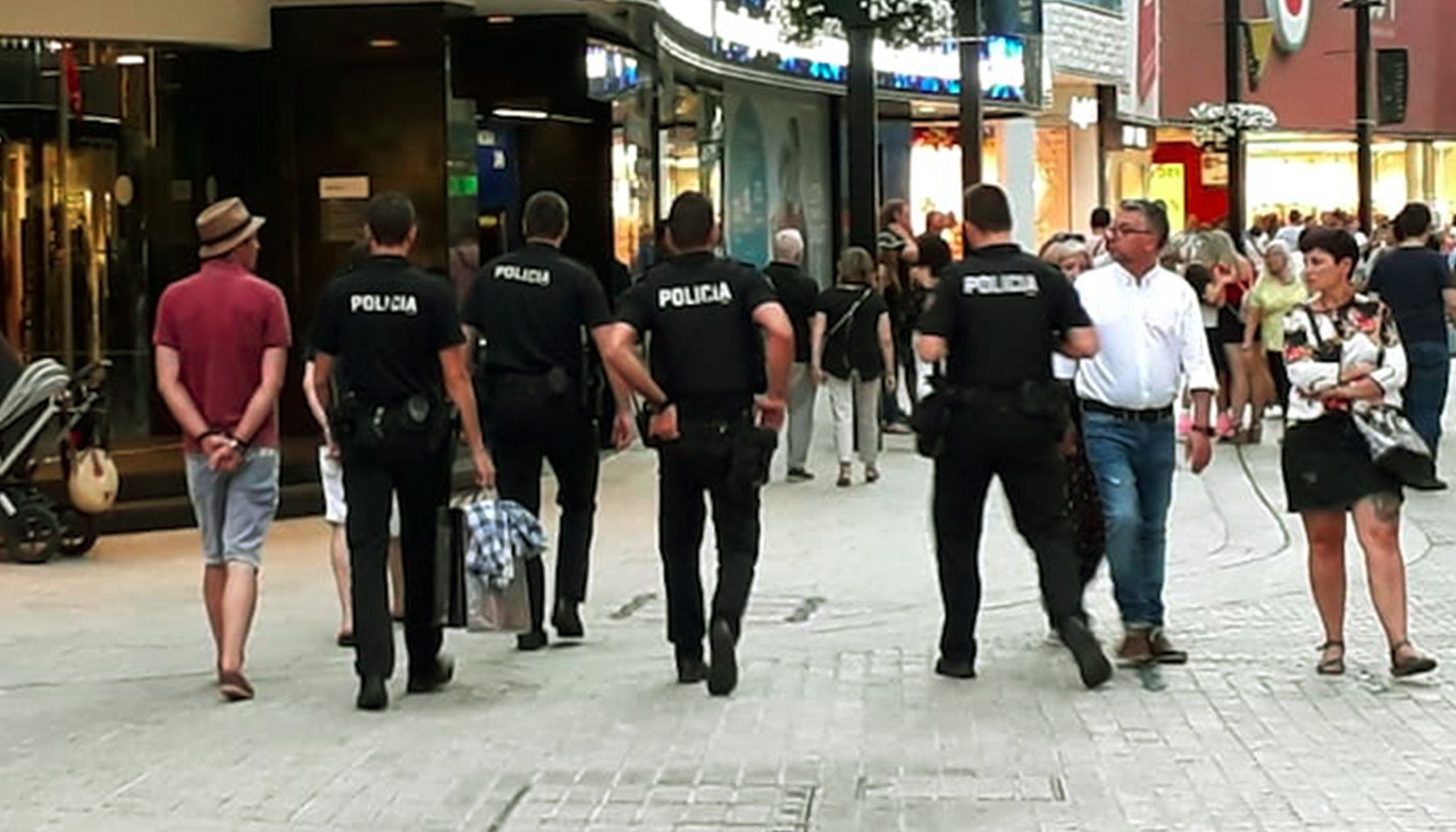 Els agents de policia s'enduen els dos homes i les bosses que duien per 'amagar' el material.