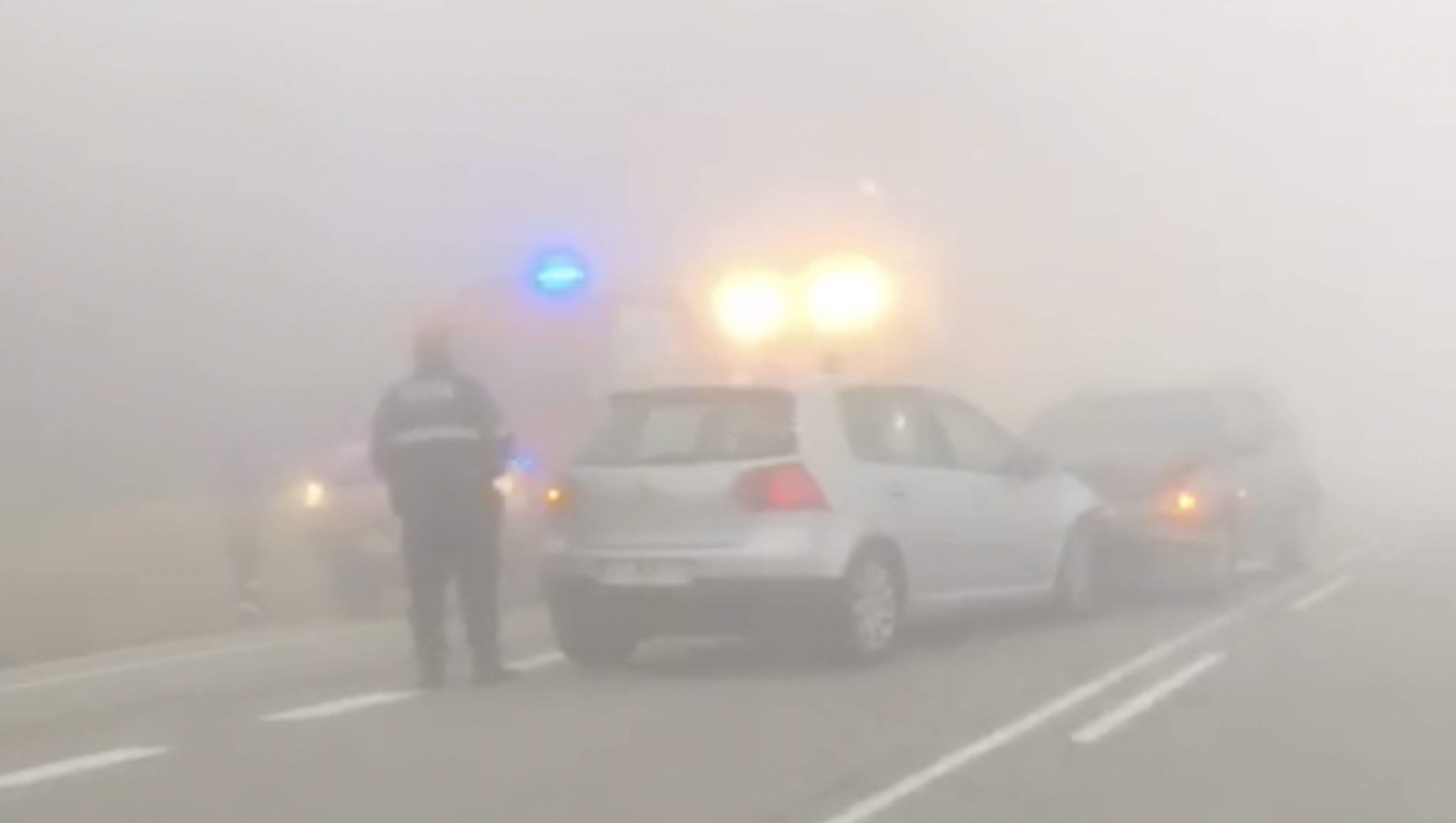 Els dos cotxes accidentats enmig d'una espessa boira.