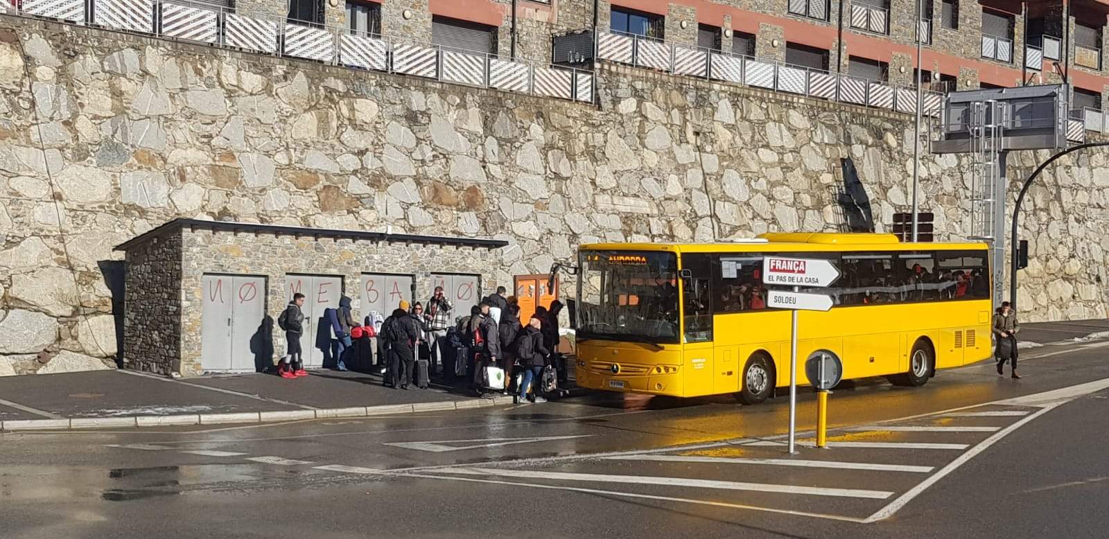 Immigrants carregats de maletes a punt d'agafar el bus per marxar del Tarter.