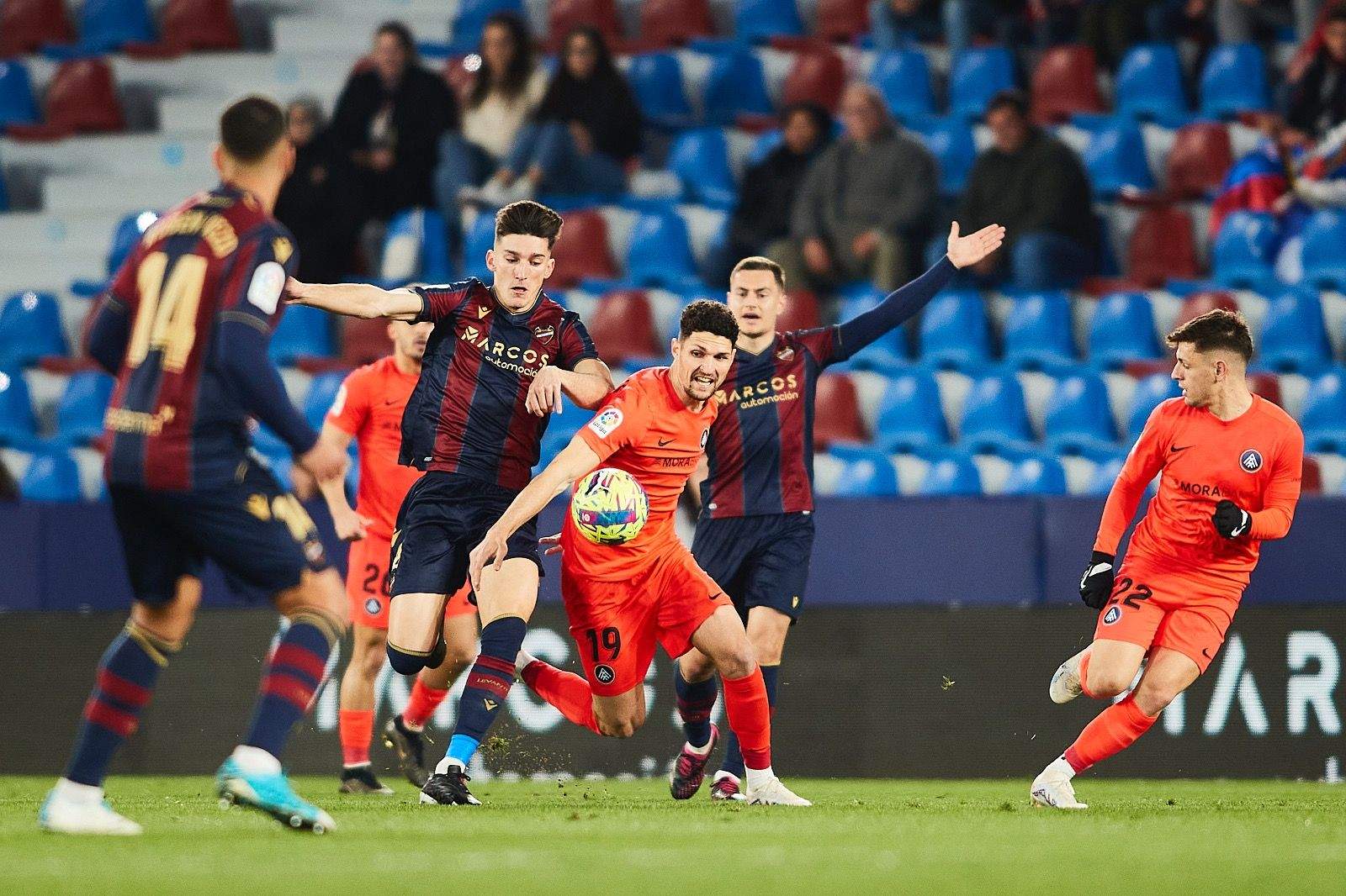 Almpanis controla una pilota entre diversos rivals.