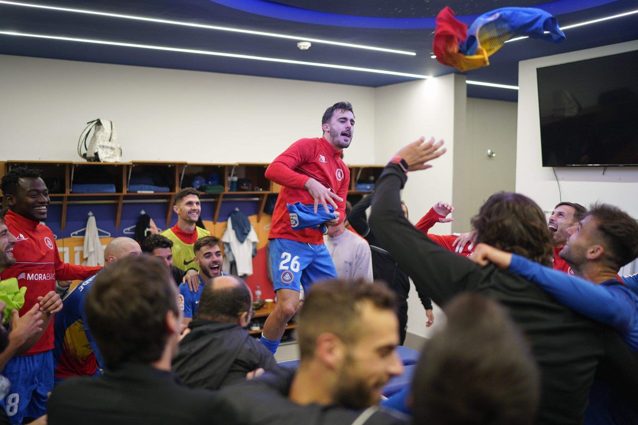 Jugadors i cos tècnic celebren la victòria contra l'Sporting al vestidor.