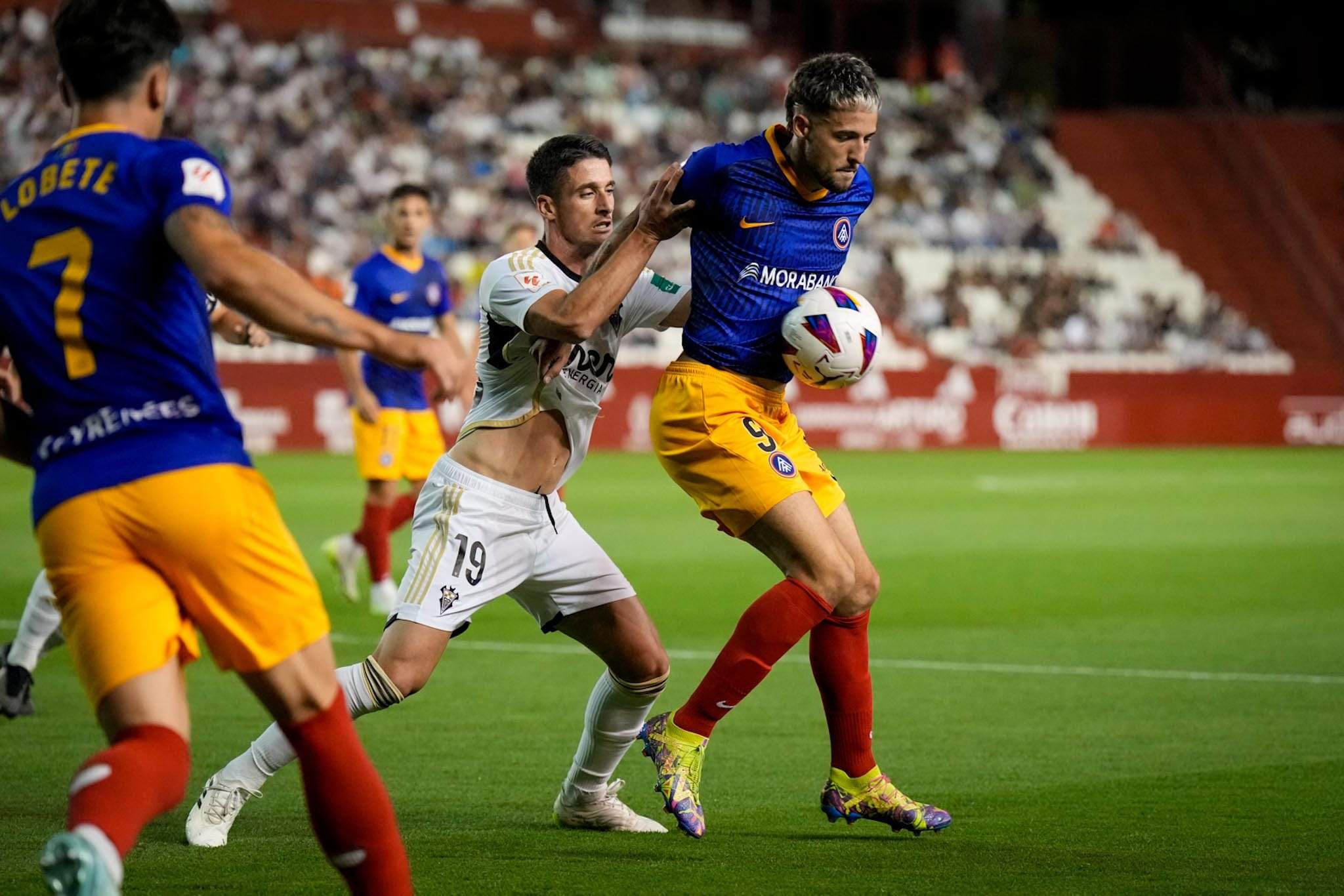Manu Nieto controlant una pilota davant la mirada d'un rival. Manu Nieto controlant una pilota davant la mirada d'un rival.