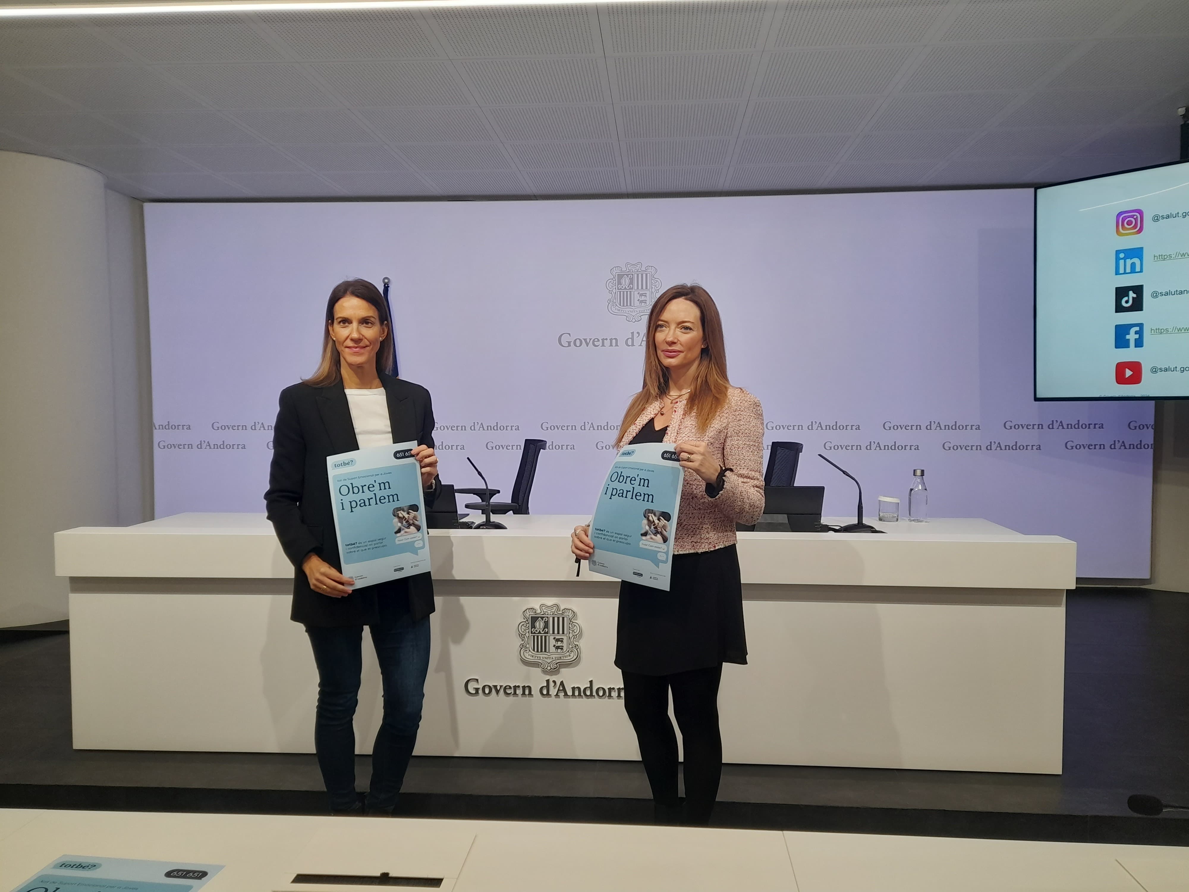 Helena Mas i Cristina Pérez amb el cartell del xat de suport emocional.