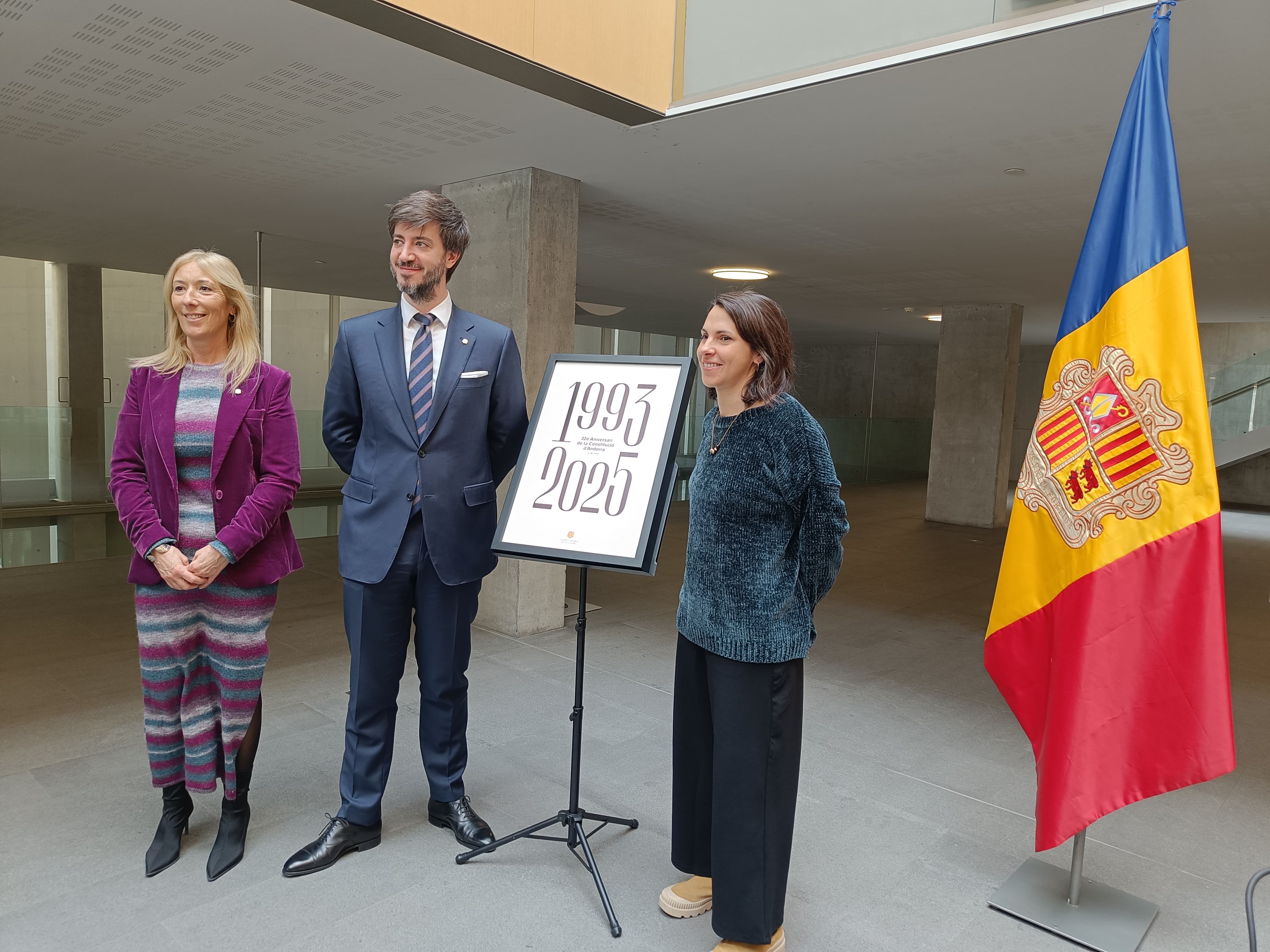 Sandra Codina, Carles Ensenyat i Irene Clua amb el cartell del Dia de la Constitució.