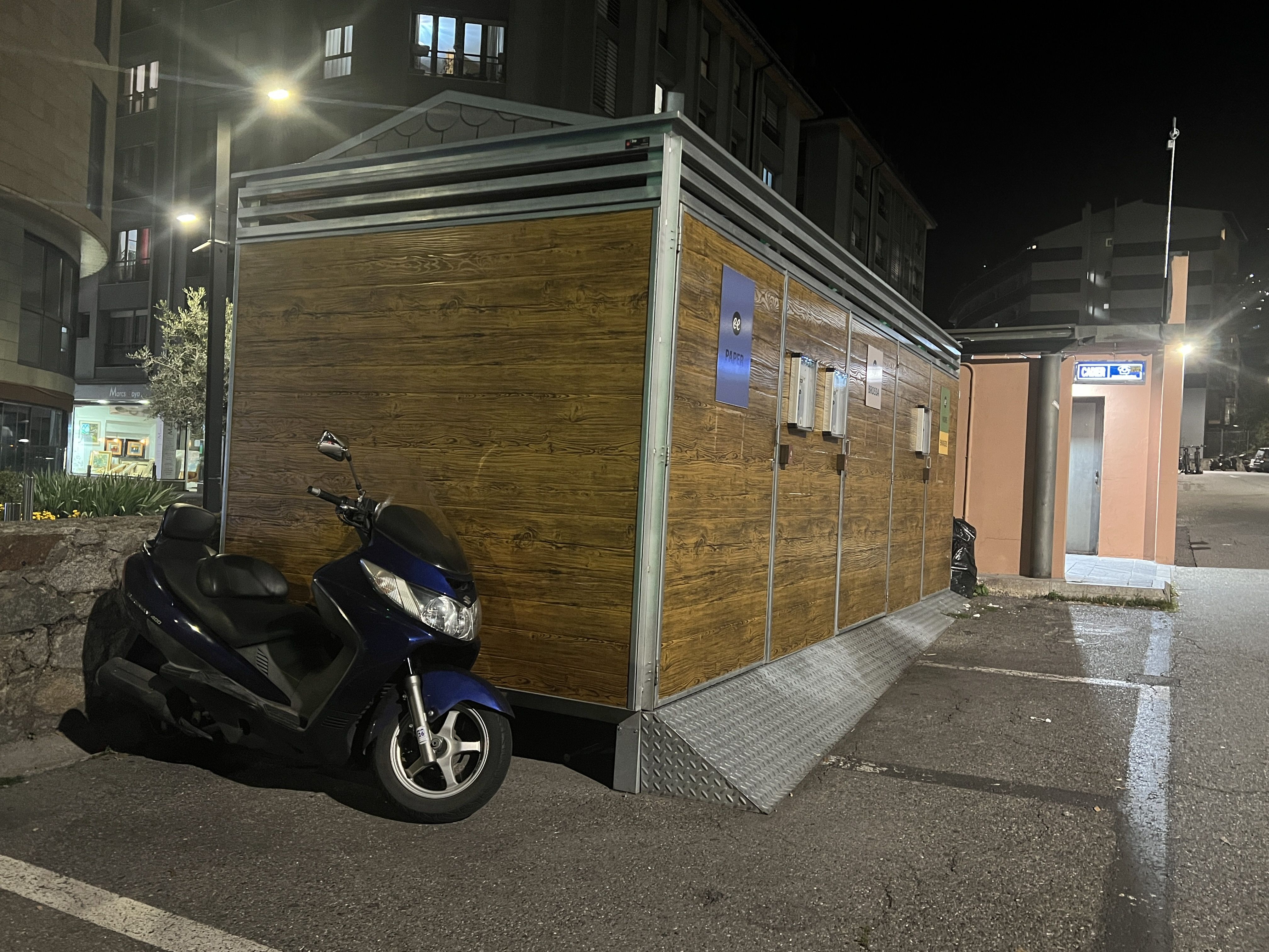 Una motocicleta estacionada al costat dels contenidors del Fener.
