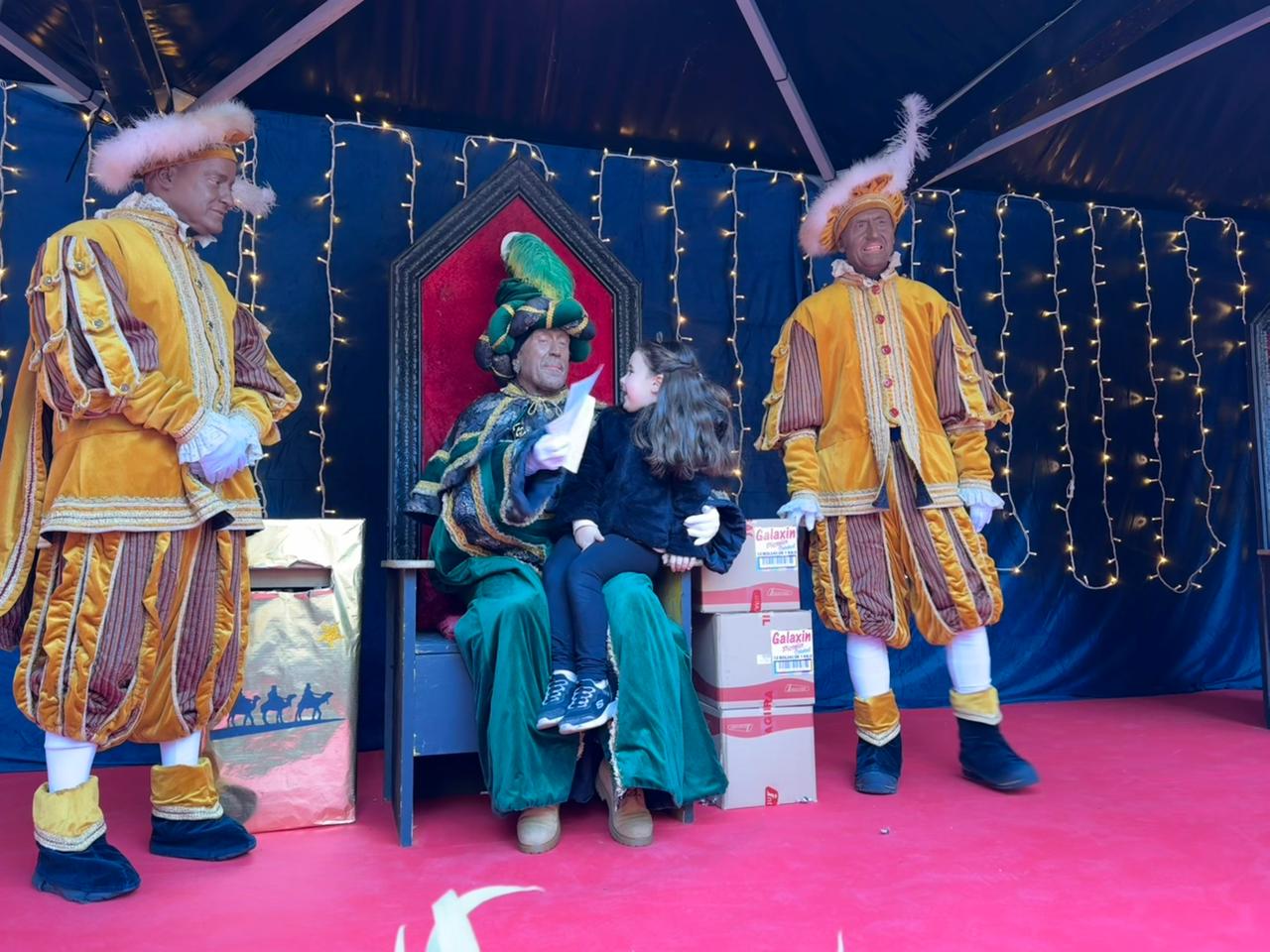 El carter i els seus ajudants rebent un dels infants que han acudit a entregar la carta.