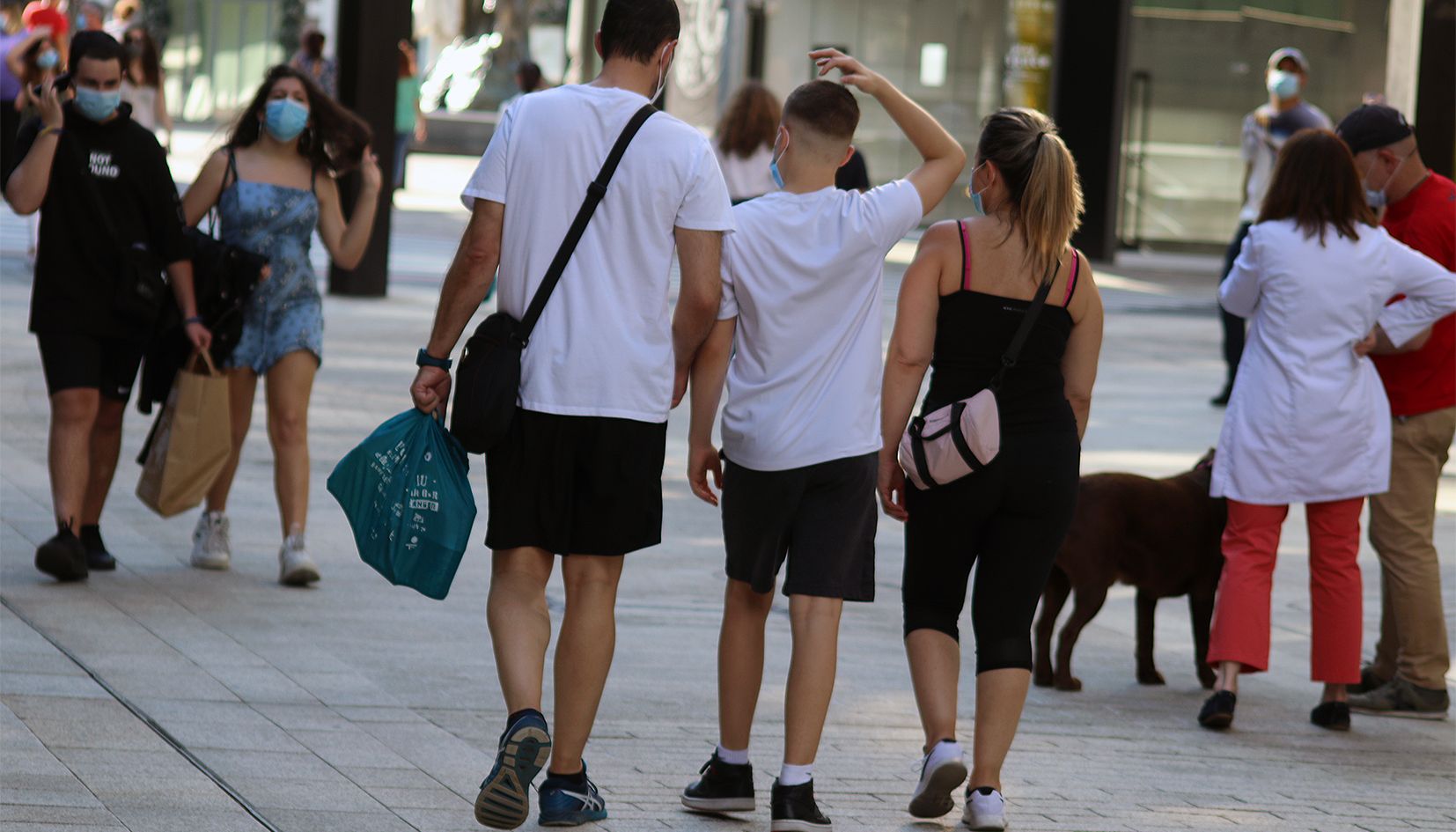 Ciutadans caminant per l'avinguda Meritxell com si ple estiu fos ja.