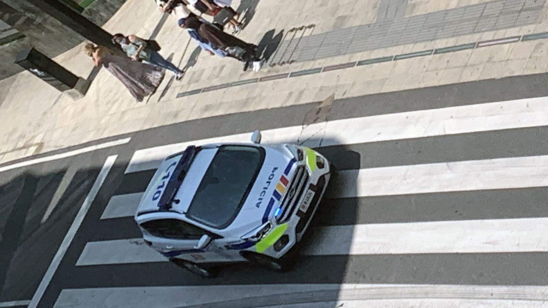 Un cotxe policial circulant per un cèntric carrer d'Andorra la Vella.