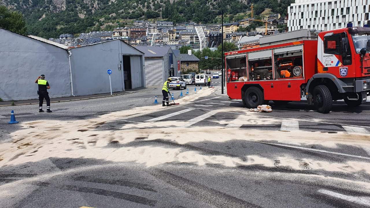 Els bombers netejant la zona amb producte absorbent